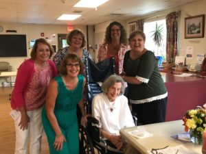 Lenore, seated at the table, with Laura, Sharon, Janet, Karen, and Vickie behind her. Not shown were Carol and Jane.