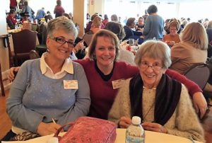 Carol, Laura and Lenore sitting at a table at the Knit Out