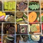 Buttons on display at the Nature Buttons vendor table, a selections of earth tones--greens, golds, browns, reds and more.